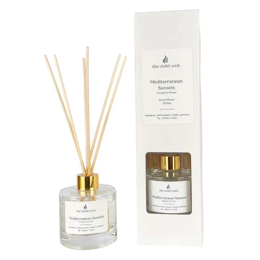 clear glass reed diffuser and white box on white background