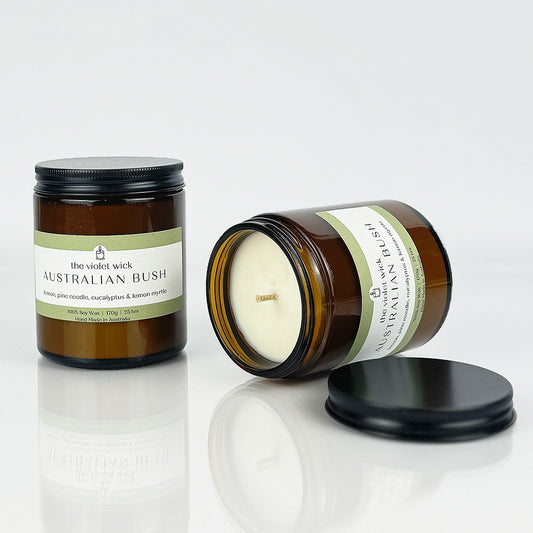 Australian Bush scented soy candle from The Violet Wick in an amber jar, with black lid, 170g.