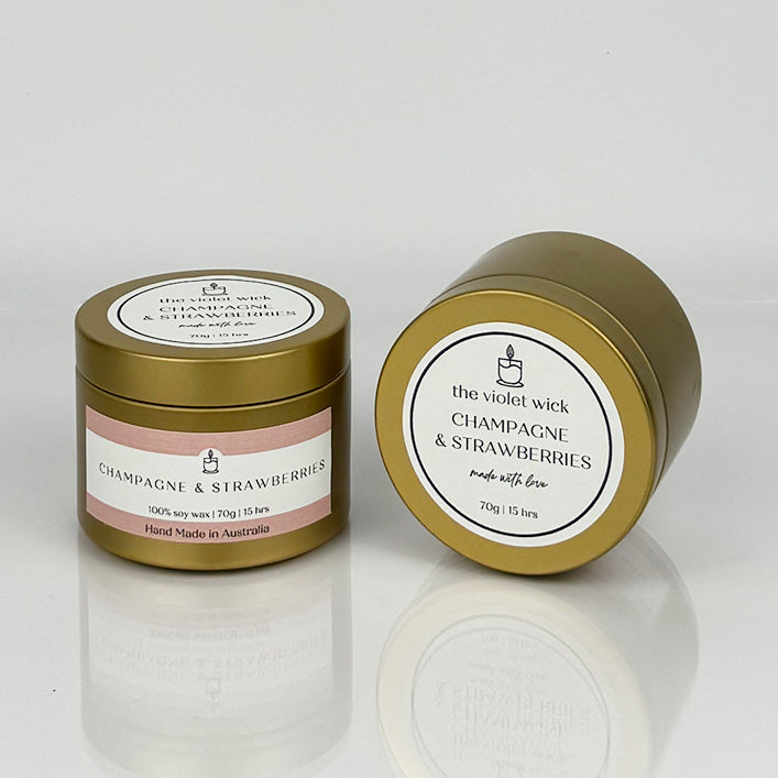 Champagne & Strawberries scented soy candle from The Violet Wick in a gold tin, 70g.