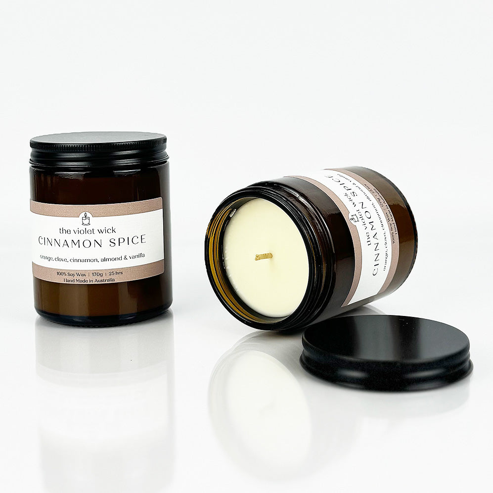 Cinnamon Spice scented soy candle from The Violet Wick in an amber jar with black lid, 170g.
