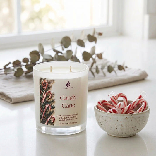 Candy Cane Soy Candle by The Violet Wick on white kitchen bench and bowl of candy canes nearby.