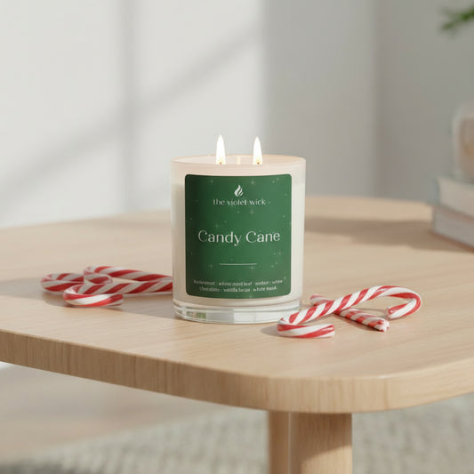 Candy Cane scented soy candle with green label on a coffee table and candy canes