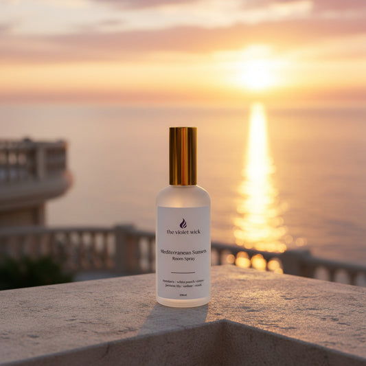 white room spray bottle labeled Mediterranean Sunsets on a balcony with sunset