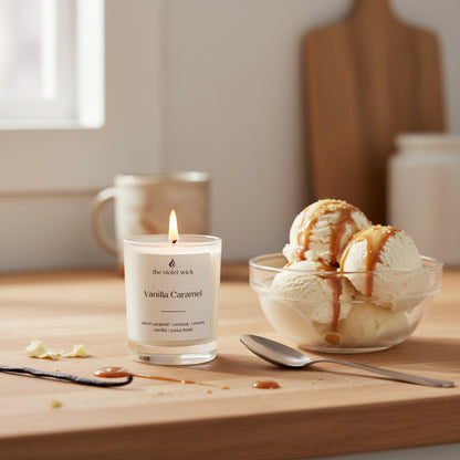small white candle on a timber bench with a bowl of vanilla icecream and caramel topping
