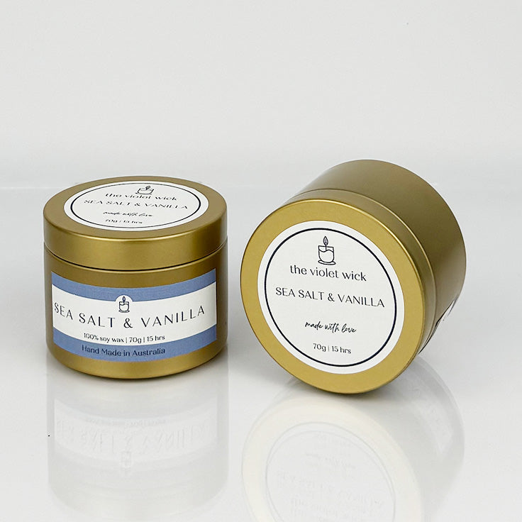 Sea Salt & Vanilla scented soy candle from The Violet Wick in a gold tin, 70g.