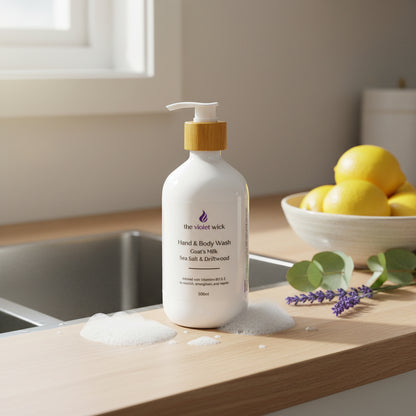 Sea Salt & Driftwood Goat's milk hand and body soap on timber kitchen bench near sink with bowl of lemons, eucalyptus leaves and lavender flowers