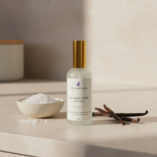white room spray bottle labeled Sea Salt & Vanilla on kitchen bench with sea salt and vanilla.