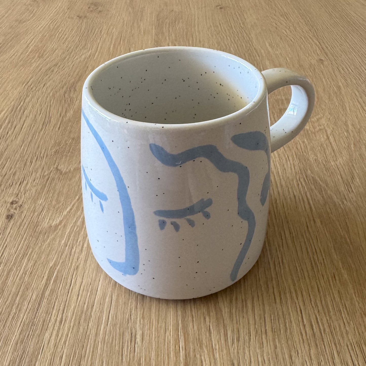 Stoneware mug with light blue face from The Violet Wick