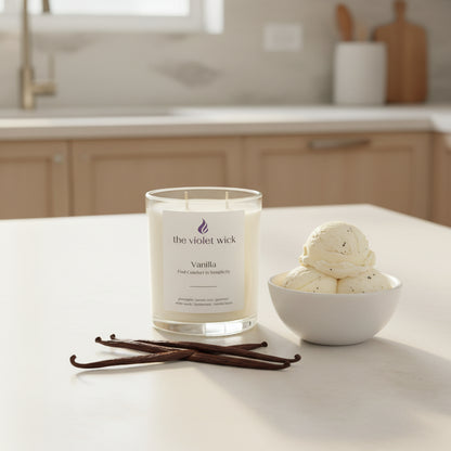 Vanilla soy candle on kitchen bench with bowl of vanilla ice cream and vanilla pods