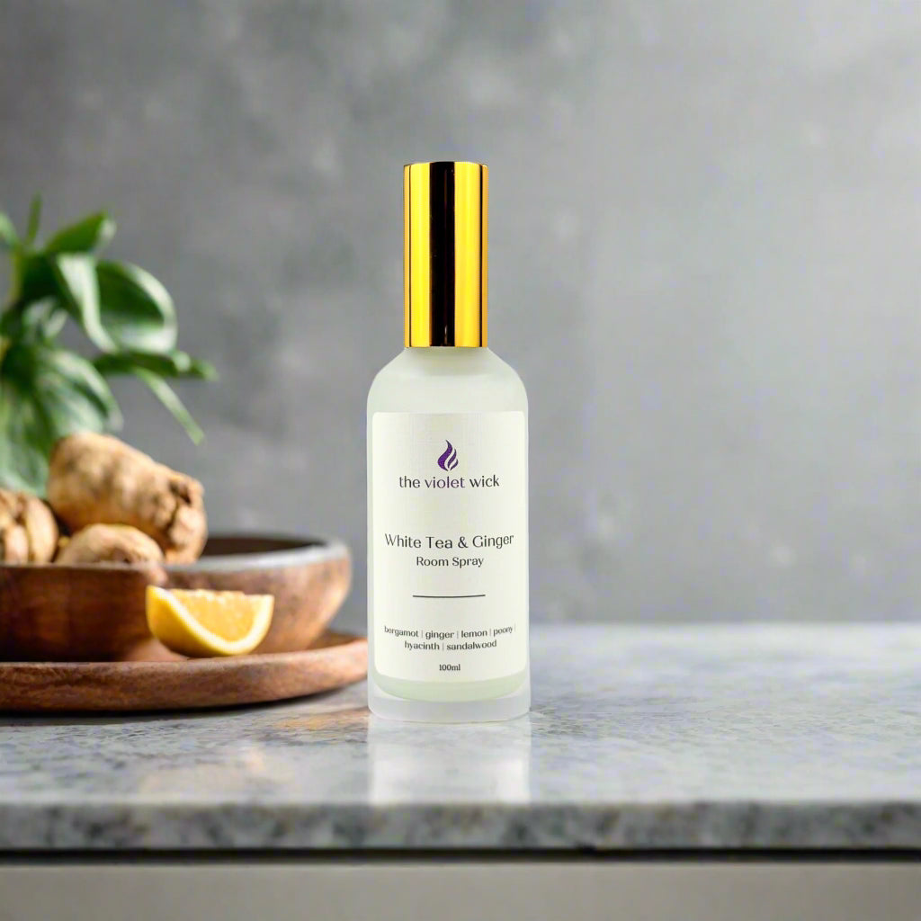 White Tea & Ginger Room Spray by The Violet Wick with ginger and lemon in background